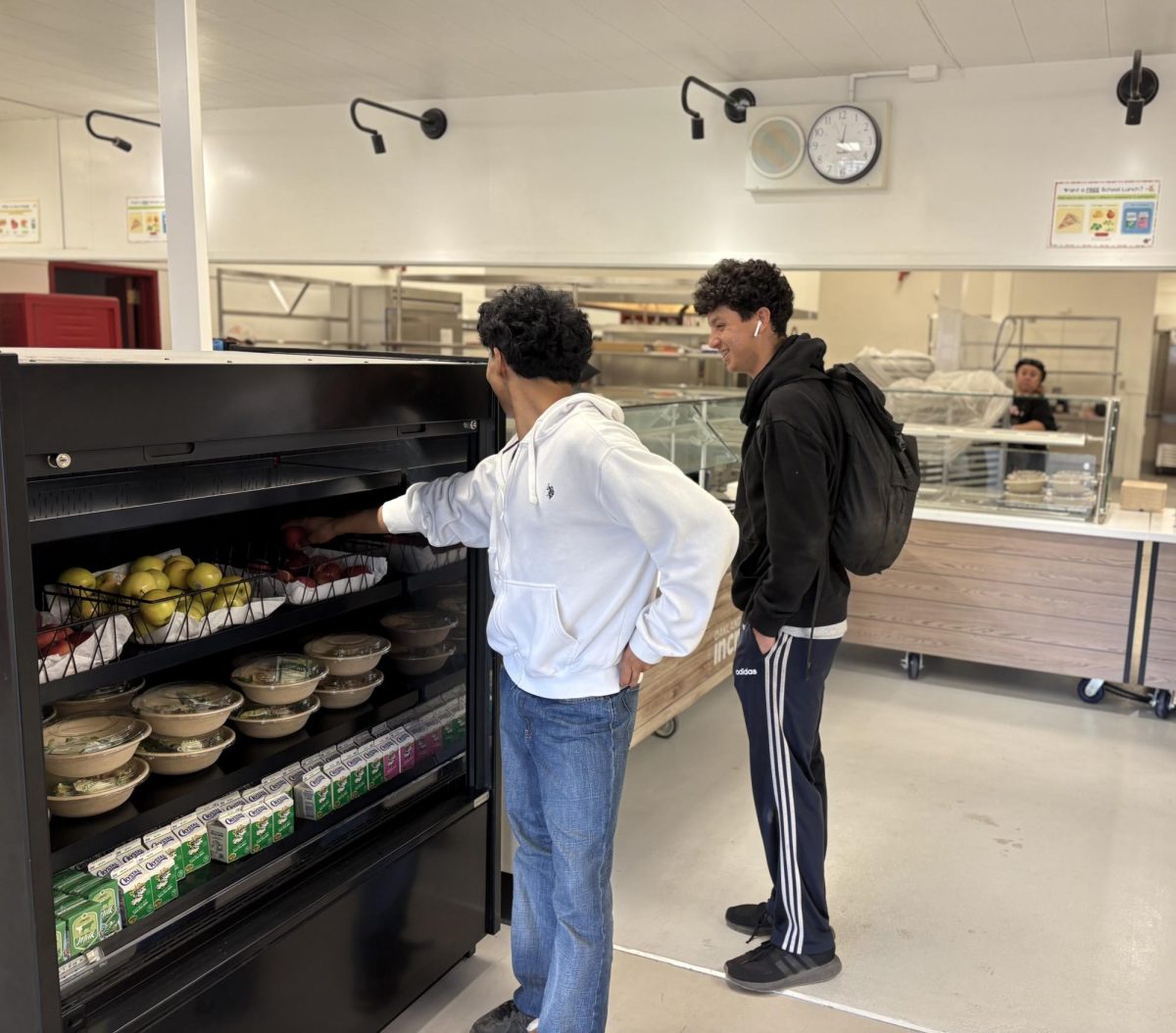 CAFETERIA CHANGES Seniors Elliot Chin (left) and Elias Hartog pick up fruit from a new grab and go refrigerator .
While many students say the cafeteria upgrades have done little to alter their experience, Principal Rebecca Huang
said more changes are coming, including phone charging stations and Skyline branding.