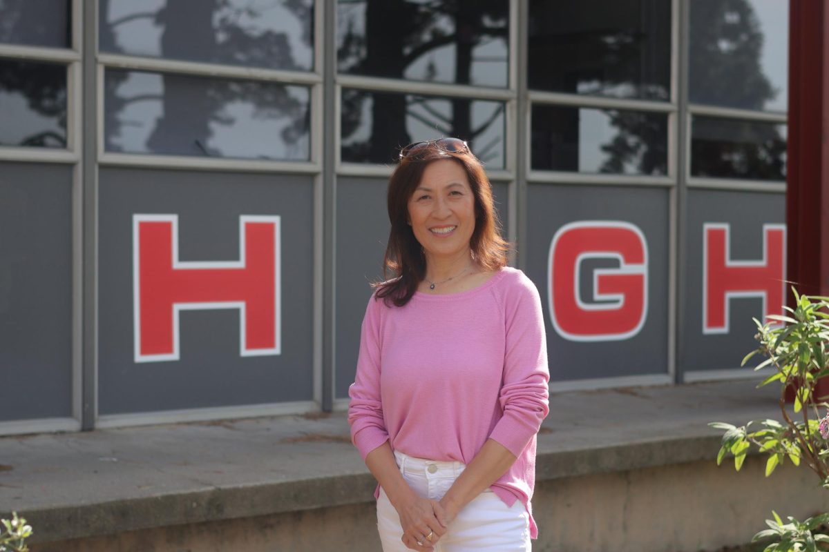TOP TITAN Principal Rebecca Huang stands outside the administration building of Skyline High School, where she leads with a focus on student safety and connection. After beginning her career in science and education, Huang now works to create a campus where students feel supported and heard.