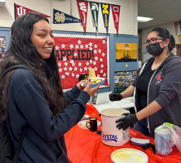 SWEET SUPPORT Senior Sarai Ojeda Sandoval receives a sundae from Jasmine Cisneros Pena in the College & Career Center (CCC) on May 12 for completing her
financial aid application. The CCC is being credited for helping students like Ojeda Sandoval get into the most selective UCs. Ojeda Sandoval will attend UC Davis.